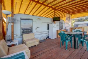 a living room with a table and chairs and a refrigerator at Camping Saint George in Topola