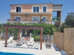a villa with a swimming pool and a house at apartman Bruna in Šibenik