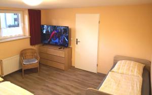 a bedroom with a bed and a tv on a dresser at Havelapartments in Berlin