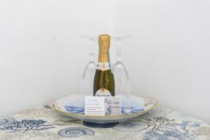a bottle of wine on a plate on a table at La Bella Annacapri in Anacapri