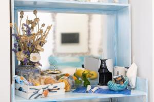 a blue shelf with a vase and other items on it at La Bella Annacapri in Anacapri