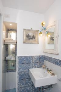 a bathroom with a sink and a mirror at La Bella Annacapri in Anacapri