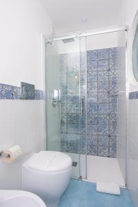 a bathroom with a toilet and a glass shower at La Bella Annacapri in Anacapri