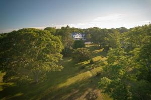 an aerial view of a house in the middle of trees at The Chequit in Shelter Island Heights