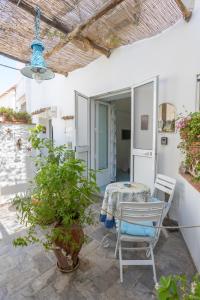 a patio with a table and chairs in a house at La Bella Annacapri in Anacapri