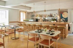 a restaurant with tables and chairs and a bar at The Chequit in Shelter Island Heights