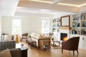 a living room with a couch and a fireplace at The Chequit in Shelter Island Heights