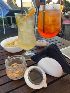 two drinks sitting on top of a wooden table at La Casetta di Ninetta in Ustica