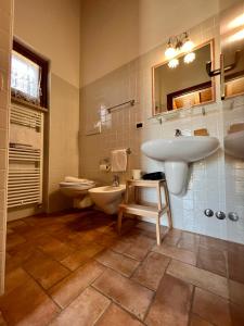 a bathroom with a sink and a toilet at Casale Terre Rosse in Saturnia