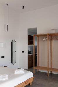 a white room with a bed and a kitchen at Stremma Naxos in Aliko Beach +33 photos
