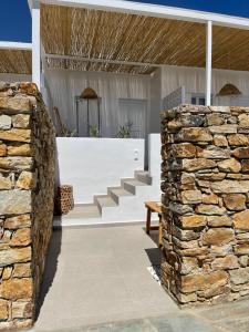 a stone wall in front of a house at Kastro Antiparos in Antiparos