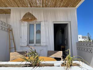 a bedroom with a bed and a table and chairs at Kastro Antiparos in Antiparos
