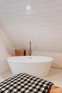 a white bath tub in a room with a sink at Maison d'hôtes Bel Estiu in Saint-Geniès