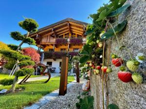 a house with some fruit on the side of it at Ferienwohnungen Anni im Paradies in Kiefersfelden