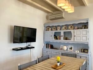 d'une salle à manger avec une table et une télévision à écran plat. dans l'établissement Villa Dreams, à Antiparos