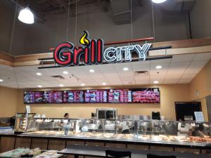 a grill city sign hanging over the counter of a restaurant at Deluxe King Size Ensuite bed room near the airport in Mississauga