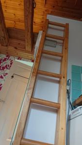 a ladder on a bed in a room at Studio house in quiet area in Stocksund