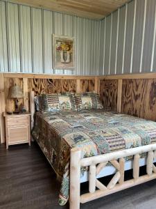 a bed with a wooden frame in a room at Brushcreek Falls RV Resort in Princeton