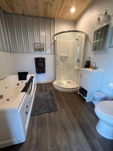 a bathroom with a shower and a sink and a toilet at Brushcreek Falls RV Resort in Princeton
