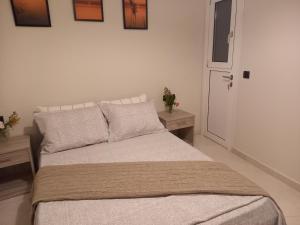 a bedroom with a large bed with two tables at Nebulous Apartment in Zakynthos Town