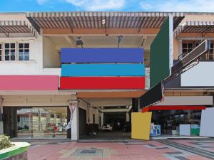 a building with colorful stairs in a shopping mall at OYO 91354 Hotel Mutiara in Magelang