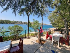 ein Tisch und Stühle mit Blick auf das Wasser in der Unterkunft Villa Riva in Omišalj + 26 Fotos