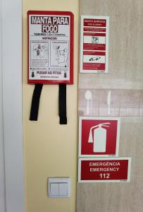 a bathroom door with signs on the wall at Fernandes House in Paredes de Coura