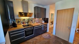 a kitchen with a sink and a stove top oven at Auszeit im Bad Diezlings in Hörbranz