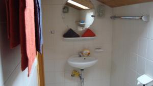 a bathroom with a sink and a mirror at Apartment Utschneider-Holzer in Bad Bayersoien
