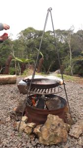 a fire pit in a rocky area with at Morada do Xaxim - Chalé Hortência in São Francisco de Paula
