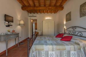 a bedroom with a large bed with red pillows at Agriturismo I Cerroni Montescudaio in Montescudaio +33 photos