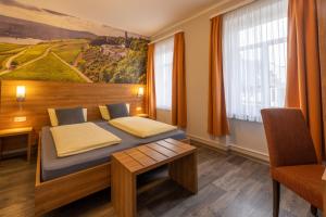 Schlafzimmer mit einem Bett mit Wandgemälde in der Unterkunft Zur Lindenau in Rüdesheim am Rhein