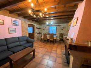a living room with a blue couch and a table at Vivienda Vacacional La Vara VV-1433-AS in Arriondas