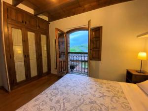 a bedroom with a bed and a view of a balcony at Vivienda Vacacional La Vara VV-1433-AS in Arriondas