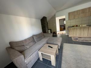 a living room with a couch and a coffee table at Mokra Gora Central Apartments in Mokra Gora