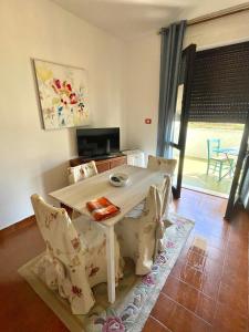 una mesa blanca y sillas en la sala de estar. en La terrazza sul MARE Manfredonia, en Manfredonia