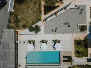 an overhead view of a swimming pool with plants at Casa Costa Suites in Kanali