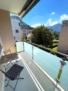 a balcony with a view of a tennis court at Cozy apartment with Free Parking & close to Lake in Lugano