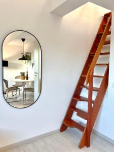 a mirror on a wall next to a stairway at GALLERY APARTMENT: MAISONETTE + FREE PARKING + NETFLIX in Essen