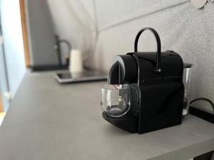 a black bag sitting on a counter with a glass at Epic House in Międzylesie