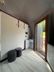 a room with two stools and a sliding glass door at Epic House in Międzylesie