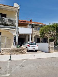 a white car parked in front of a building at APARTMAN SMOLJIC 4+2 in Primošten +18 photos