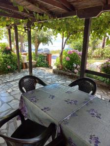 a table and chairs on a patio with flowers at IVAN Apartment in Peštani