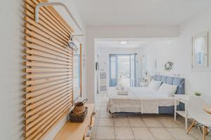 A bed or beds in a room at Anemomiloi Studios