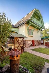 ein Haus mit einem Vogelfutter auf einem Baum in der Unterkunft Tamás Apartman Balatonföldvár szívében- egész évben nyitva! in Balatonföldvár