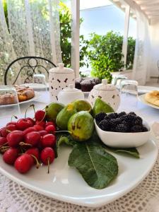 een bord groenten en fruit op een tafel bij Casa Poesia in Torre San Giovanni Ugento