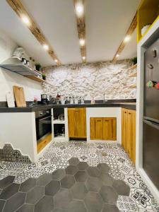 a kitchen with black and white tiles on the floor at Bell Tower House in Novi Vinodolski +33 photos