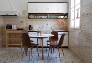 a kitchen with a table and chairs in a room at Kilada Country House in Kilada