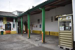 a gas station with green poles in a parking lot at La Puerta Rota in Zipaquirá