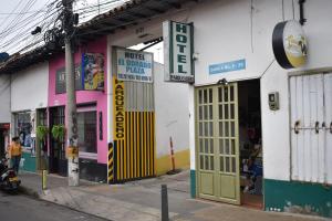 a store front with a yellow door on a street at La Puerta Rota in Zipaquirá